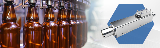 Linear motor solution for automated beverage bottling lines with brown glass bottles on a high‑speed production conveyor.